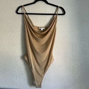 Medium,Tan body by “And Now This”